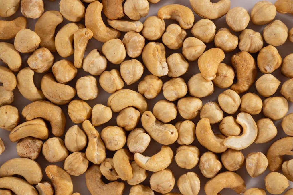 Cashews and hazelnuts spread on a flat surface